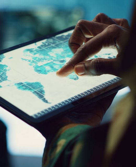 Military IT professional gathers intelligence from world map projection Military IT professional gathers intelligence from world map projection, tablet connected to satellite reconnaissance system to support field troops. Dispatch army command post. Close up. Camera A.